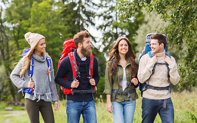 Image showing group of smiling friends with backpacks hiking