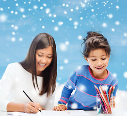 Image showing mother and daughter with coloring pencils indoors