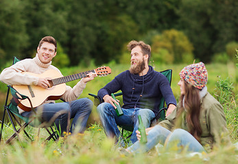 Image showing group of tourists playing guitar in camping