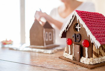 Image showing close up of woman making gingerbread houses