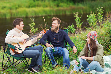 Image showing group of tourists playing guitar in camping