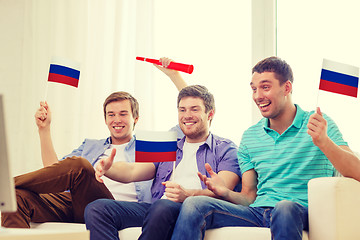 Image showing happy male friends with flags and vuvuzela