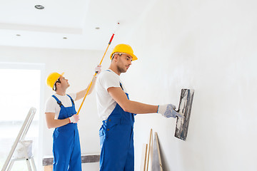 Image showing group of builders with tools indoors