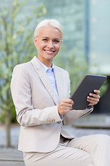 Image showing smiling businesswoman with tablet pc outdoors