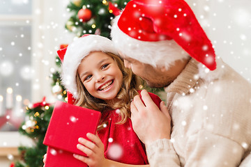 Image showing smiling father and daughter holding gift box