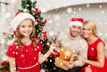 Image showing smiling family decorating christmas tree at home