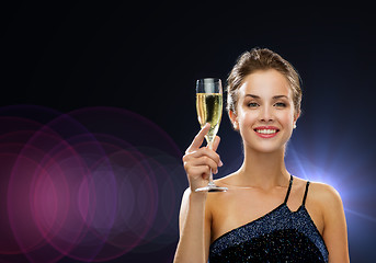 Image showing smiling woman holding glass of sparkling wine