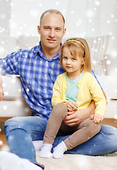 Image showing smiling father and daughter hugging at home