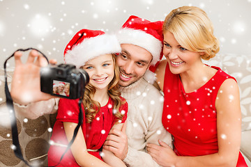 Image showing happy family with digital camera taking photo