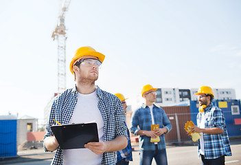 Image showing group of builders in hardhats outdoors