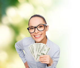 Image showing smiling businesswoman with dollar cash money