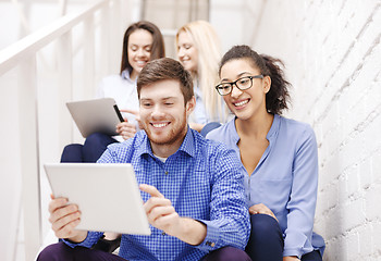 Image showing team with tablet pc computer sitting on staircase