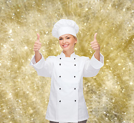 Image showing smiling female chef showing thumbs up