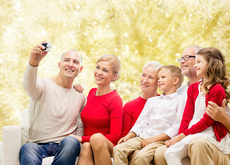 Image showing smiling family with camera