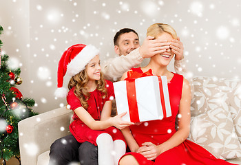 Image showing smiling family with gift box