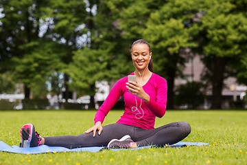 Image showing smiling african american woman with smartphone