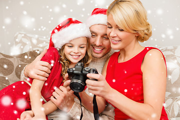 Image showing happy family with digital camera at home