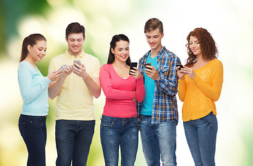 Image showing group of smiling teenagers with smartphones