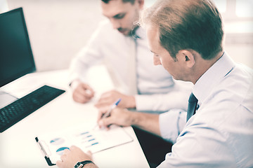 Image showing businessmen with notebook on meeting