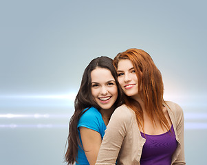 Image showing smiling teenage girls hugging