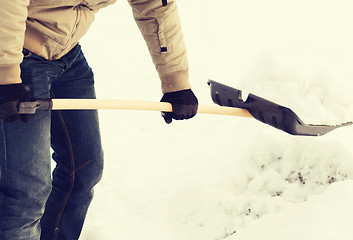 Image showing closeup of man shoveling snow from driveway