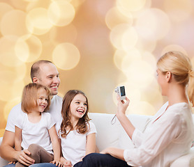 Image showing happy family with camera at home