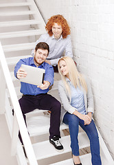 Image showing team with tablet pc computer sitting on staircase