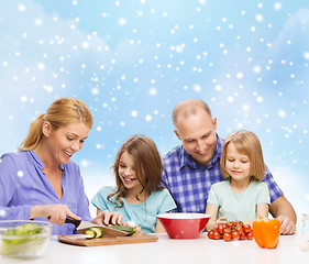 Image showing happy family with two kids making dinner at home