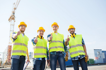 Image showing group of smiling builders with tablet pc outdoors