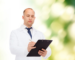 Image showing serious male doctor with clipboard