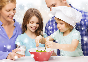 Image showing happy family with two kids making salad at home