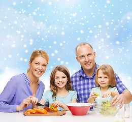 Image showing happy family with two kids making dinner at home