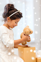 Image showing smiling little girl with gift box and toy