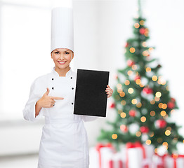 Image showing smiling female chef with black blank paper