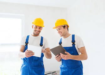 Image showing builders with tablet pc and equipment indoors