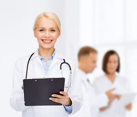 Image showing smiling female doctor with clipboard