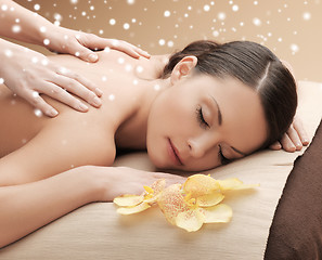 Image showing beautiful young woman in spa salon getting massage