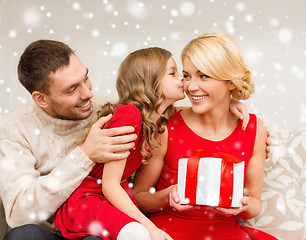 Image showing smiling family holding gift box