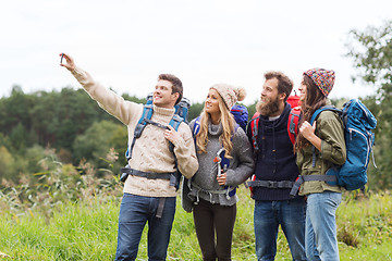 Image showing group of friends with backpacks taking selfie