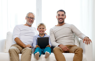 Image showing smiling family with tablet pc at home