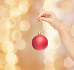 Image showing close up of woman in sweater with christmas ball