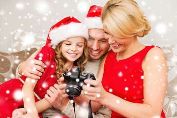 Image showing happy family with digital camera at home