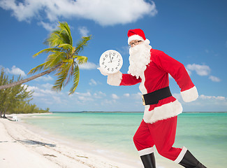 Image showing man in costume of santa claus with clock