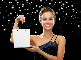 Image showing smiling woman with white blank shopping bag