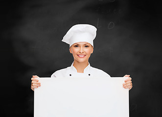 Image showing smiling female chef with white blank board