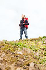 Image showing tourist with beard and backpack raising hands