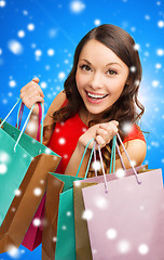 Image showing smiling woman with colorful shopping bags