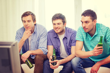 Image showing happy male friends with beer watching tv at home