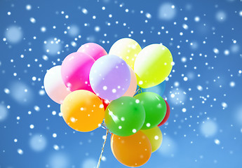 Image showing lots of colorful balloons in sky with snowflakes