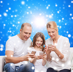 Image showing happy family with smartphones